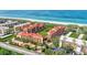 Aerial view showing condo community near the ocean with resort-style amenities at 8750 Midnight Pass Rd # 202, Sarasota, FL 34242