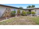 Landscaped front yard with stone accents and manicured lawn at 2132 Abscott St, Port Charlotte, FL 33952