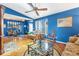 Living room with hardwood floors, blue walls, and ample natural light at 2132 Abscott St, Port Charlotte, FL 33952