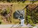 Aerial view highlighting home, driveway, and natural wooded surroundings on an expansive lot at 5823 Kumquat Ave, North Port, FL 34291