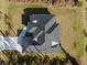 Overhead shot showcasing a home's roof, driveway, and well-maintained surrounding yard at 5823 Kumquat Ave, North Port, FL 34291