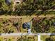 Scenic aerial perspective of a home surrounded by serene woods, ensuring ultimate privacy at 5823 Kumquat Ave, North Port, FL 34291