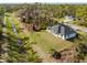 Expansive aerial view of a modern home, nestled amidst lush greenery and a serene waterway at 5823 Kumquat Ave, North Port, FL 34291