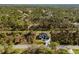 Expansive aerial showing a home set on a verdant lawn with picturesque wooded boundaries at 5823 Kumquat Ave, North Port, FL 34291