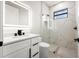 Modern bathroom with floating vanity, black hardware, and sleek glass enclosed shower with eye-catching tile work at 5823 Kumquat Ave, North Port, FL 34291