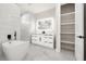Bright white modern bathroom featuring a standalone tub and walk-in closet at 5823 Kumquat Ave, North Port, FL 34291