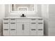 Bathroom vanity featuring an undermount sink and bright illuminated mirror at 5823 Kumquat Ave, North Port, FL 34291