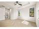 Bedroom with plank floors, tray ceilings, black trim windows and an ensuite bathroom at 5823 Kumquat Ave, North Port, FL 34291