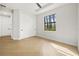 Bright bedroom featuring wood floors in a herringbone pattern, and a modern ceiling fan at 5823 Kumquat Ave, North Port, FL 34291
