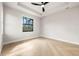 Light and bright bedroom with hardwood floors, black trim windows and a ceiling fan at 5823 Kumquat Ave, North Port, FL 34291