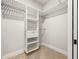 Walk-in closet featuring white shelving units and ample storage space at 5823 Kumquat Ave, North Port, FL 34291