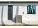 Side exterior view of a white home with a dark door, window, and a Lennox A/C unit at 5823 Kumquat Ave, North Port, FL 34291