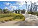 Charming single-story home with well-maintained lawn and elegant brick driveway at 5823 Kumquat Ave, North Port, FL 34291