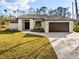 Beautiful single-story home featuring a lush lawn, paved driveway, and modern design at 5823 Kumquat Ave, North Port, FL 34291
