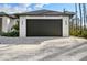 Close up of the garage door with dark facade lights at 5823 Kumquat Ave, North Port, FL 34291