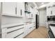 Elegant kitchen design with white cabinets, stainless steel appliances, and sleek black hardware at 5823 Kumquat Ave, North Port, FL 34291