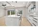 Bright open kitchen featuring a large island, modern lighting, and plank floors at 5823 Kumquat Ave, North Port, FL 34291