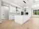 Well-lit kitchen featuring white cabinetry, stainless steel appliances, and a center island at 5823 Kumquat Ave, North Port, FL 34291