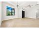 Bright living area with a modern chandelier, large windows, and light hardwood floors at 5823 Kumquat Ave, North Port, FL 34291