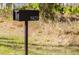 Modern black mailbox displaying the house number '5823' in a sunny front yard at 5823 Kumquat Ave, North Port, FL 34291