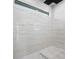 Modern shower featuring luxurious marble tile walls and horizontal window at 5823 Kumquat Ave, North Port, FL 34291