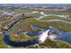 Aerial view showcasing a property with a unique waterway and lush landscape at 32091 Serene Dr, Punta Gorda, FL 33982