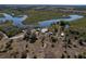 Aerial view of a waterfront property with a home and several outbuildings at 32091 Serene Dr, Punta Gorda, FL 33982