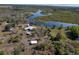 Aerial view of property with home, RV, and outbuildings near a waterway at 32091 Serene Dr, Punta Gorda, FL 33982