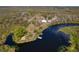 An aerial view of a home and several outbuildings near a calm waterway at 32091 Serene Dr, Punta Gorda, FL 33982