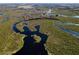 Aerial view of waterfront property with winding waterways and lush vegetation at 32091 Serene Dr, Punta Gorda, FL 33982