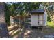 Chicken coop and run in a wooded backyard setting at 16461 Chicopee Ave, Port Charlotte, FL 33954