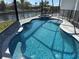 A beautiful pool with clear blue water, stone pavers, and a black safety fence at 1426 Mineo Dr, Punta Gorda, FL 33950