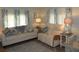 Spacious living room with two couches, patterned pillows, and coastal decor at 6405 Kilohee Ct, North Port, FL 34287