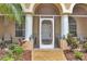 Inviting front entrance with decorative columns, lush plants, and a screened entry at 17180 Cape Horn Blvd, Punta Gorda, FL 33955