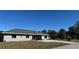 Newly constructed single-story home with a gray exterior, driveway, and landscaping at 17352 Terry Ave, Port Charlotte, FL 33948