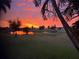 Stunning sunset view over a peaceful lake and golf course at 437 Madrid Blvd, Punta Gorda, FL 33950