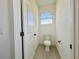 Clean and modern powder room with toilet and single sink at 26345 Trinilas Dr, Punta Gorda, FL 33983