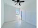 Spacious bedroom with ceiling fan and large window at 26345 Trinilas Dr, Punta Gorda, FL 33983