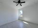 Spacious bedroom with ceiling fan and window at 26345 Trinilas Dr, Punta Gorda, FL 33983