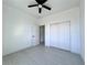 Bedroom with sliding door closet and ceiling fan at 26345 Trinilas Dr, Punta Gorda, FL 33983