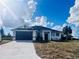 Newly built home with dark brown garage door and white exterior at 26345 Trinilas Dr, Punta Gorda, FL 33983