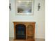 Wood-look fireplace with built-in shelving and artwork above at 269 Franca St, Punta Gorda, FL 33983