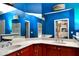 Bathroom with a double vanity and blue walls at 17258 Acapulco Rd # 122, Punta Gorda, FL 33955
