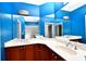 Double vanity bathroom with blue walls and corner sink at 17258 Acapulco Rd # 122, Punta Gorda, FL 33955
