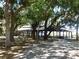 Wooden gazebo shaded by lush trees in a park-like setting at 17258 Acapulco Rd # 122, Punta Gorda, FL 33955