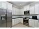 Modern kitchen with stainless steel appliances and white shaker cabinets at 17258 Acapulco Rd # 122, Punta Gorda, FL 33955