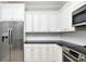 Modern kitchen with stainless steel appliances and white cabinets at 17258 Acapulco Rd # 122, Punta Gorda, FL 33955