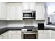 Sleek kitchen with granite countertops and stainless steel appliances at 17258 Acapulco Rd # 122, Punta Gorda, FL 33955