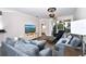 Bright living room with comfy sectional sofa, large TV, and access to balcony at 17258 Acapulco Rd # 122, Punta Gorda, FL 33955