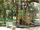 Community playground with playset and bench under the trees at 17258 Acapulco Rd # 122, Punta Gorda, FL 33955